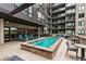 Outdoor pool deck featuring a hot tub, seating areas, and scenic views of the property at 20 Wilcox St # 309, Castle Rock, CO 80104