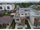 Aerial shot of modern townhomes with rooftop decks, nestled in a green community with mountain views at 1355 Zenobia St, Denver, CO 80204