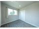 Cozy bedroom with plush carpet, neutral tones, and a large window at 1355 Zenobia St, Denver, CO 80204