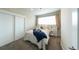 Cozy bedroom with a large window, sliding door closet, and neutral decor at 1355 Zenobia St, Denver, CO 80204