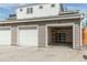 Exterior view of a three car garage with one door open and shelving inside at 1355 Zenobia St, Denver, CO 80204