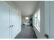 Bright hallway leading to an office, featuring neutral paint and plush carpet flooring at 1355 Zenobia St, Denver, CO 80204