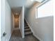 Bright hallway featuring carpet, a staircase, and a window for natural light at 1355 Zenobia St, Denver, CO 80204