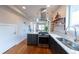 Stylish kitchen featuring a center island, stainless steel appliances, and wood floors at 1355 Zenobia St, Denver, CO 80204