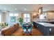 Open living area featuring a dining table, kitchen island, and comfortable living space at 1355 Zenobia St, Denver, CO 80204