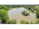High-angle shot of a calm lake dotted with trees and small islands, framed by dense, green foliage at 3354 W Arlington Ave, Littleton, CO 80123