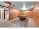 Large basement with a pool table, wood paneled walls, and carpet flooring at 3354 W Arlington Ave, Littleton, CO 80123