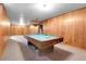 Open basement featuring a pool table, wood paneling, and carpet flooring at 3354 W Arlington Ave, Littleton, CO 80123