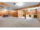 Expansive basement with a pool table, workbench, and carpet flooring at 3354 W Arlington Ave, Littleton, CO 80123