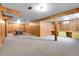 Large basement with a pool table, workbench, wood paneling, and carpet flooring at 3354 W Arlington Ave, Littleton, CO 80123