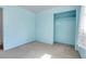 Bedroom with sky blue walls includes closet space and large window at 3354 W Arlington Ave, Littleton, CO 80123