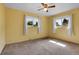 Bedroom with two windows, a ceiling fan, and tan carpet at 3354 W Arlington Ave, Littleton, CO 80123