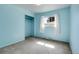 Cozy bedroom features sky blue walls, carpet, and an open closet at 3354 W Arlington Ave, Littleton, CO 80123