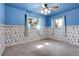 Bedroom with bright blue walls, floral wallpaper trim, and dual windows at 3354 W Arlington Ave, Littleton, CO 80123