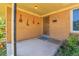 Inviting front porch features brick siding, charming decor, and a secure front door at 3354 W Arlington Ave, Littleton, CO 80123
