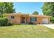 Lovely single-story brick home with a well-manicured lawn, long driveway and attached garage at 3354 W Arlington Ave, Littleton, CO 80123
