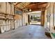 Unfinished garage with shelves and a car that is partially visible through the open garage door at 3354 W Arlington Ave, Littleton, CO 80123