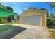 Detached yellow garage with a white door and a green awning over the patio at 3354 W Arlington Ave, Littleton, CO 80123