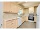 Cozy kitchen has tile countertops, backsplash, and light wood cabinets at 3354 W Arlington Ave, Littleton, CO 80123