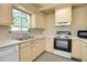 Cozy kitchen features tile countertops, backsplash, and window above sink at 3354 W Arlington Ave, Littleton, CO 80123