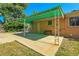 Outdoor patio with metal awning and a bench situated on brick building exterior, with views of the yard at 3354 W Arlington Ave, Littleton, CO 80123
