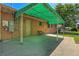 Back patio with metal awning, bench, and view of the brick exterior and backyard at 3354 W Arlington Ave, Littleton, CO 80123