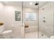 Contemporary bathroom featuring glass-enclosed shower, neutral tile, and a built-in bench under a glass block window at 2857 Linden Dr, Boulder, CO 80304