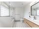 Bright bathroom with a glass block window, tiled floor, and a modern vanity with light wood cabinets at 2857 Linden Dr, Boulder, CO 80304