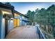 Spacious deck offering views of mature trees with sliding glass door access to the home at 2857 Linden Dr, Boulder, CO 80304