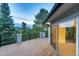 Large deck with railing offering views of mature trees and sliding glass door access to home at 2857 Linden Dr, Boulder, CO 80304