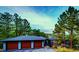 Stylish exterior featuring a large garage, modern design, and lush, mature trees at 2857 Linden Dr, Boulder, CO 80304