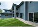 Back exterior view of the home with a covered balcony and manicured lawn at 2857 Linden Dr, Boulder, CO 80304
