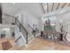 Bright entryway with wood stairs with iron railing, wood floors, and view to the dining room at 2857 Linden Dr, Boulder, CO 80304