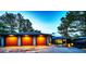 Home exterior with a three-car garage and warmly lit windows at twilight at 2857 Linden Dr, Boulder, CO 80304