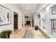 Bright hallway with hardwood floors, large windows, and modern artwork at 2857 Linden Dr, Boulder, CO 80304