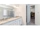 Bright bathroom boasts double vanity, granite counters, walk-in shower and access to walk-in closet at 7404 Greenwater Cir, Castle Rock, CO 80108