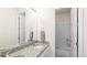 Bright bathroom with double sink vanity, granite countertop, and shower-tub combination at 7404 Greenwater Cir, Castle Rock, CO 80108