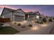 Beautifully landscaped home showcasing two-car garages and warm exterior lighting at dusk at 7404 Greenwater Cir, Castle Rock, CO 80108