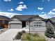 Charming single-Gathering home featuring gray siding, stone accents, and a well-maintained front yard at 7404 Greenwater Cir, Castle Rock, CO 80108