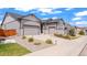 Well-maintained home showcasing a spacious driveway, a two-car garage, and tasteful landscaping at 7404 Greenwater Cir, Castle Rock, CO 80108
