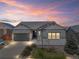 Charming single-Gathering home featuring stone accents, a well-kept lawn, and an attached two-car garage at 7404 Greenwater Cir, Castle Rock, CO 80108