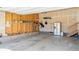 Spacious garage including upper storage, shelving, and a stainless refrigerator at 7404 Greenwater Cir, Castle Rock, CO 80108