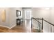Inviting hallway with hardwood floors leading to the front door and stairs, offering a warm welcome at 7404 Greenwater Cir, Castle Rock, CO 80108