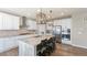 Modern kitchen featuring granite island, stainless appliances, and custom lighting, ideal for entertaining at 7404 Greenwater Cir, Castle Rock, CO 80108