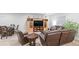 Comfortable living room with TV, shelving, and leather furniture at 7404 Greenwater Cir, Castle Rock, CO 80108