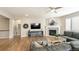 Spacious living room with hardwood floors, fireplace, and a comfortable sectional sofa, perfect for relaxing at 7404 Greenwater Cir, Castle Rock, CO 80108