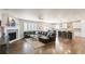 Open-concept living area with a fireplace, hardwood floors, and seamless flow to the kitchen at 7404 Greenwater Cir, Castle Rock, CO 80108