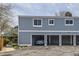 Exterior view of a multi-Gathering unit showing its carports and blue siding at 2557 S Dover St # 25, Lakewood, CO 80227