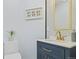 Stylish bathroom with navy blue vanity, gold fixtures, and decorative tile at 3425 W 111Th Loop # B, Westminster, CO 80031