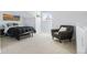 Cozy bedroom with neutral tones, a reading chair, and a comfortable bed at 3425 W 111Th Loop # B, Westminster, CO 80031